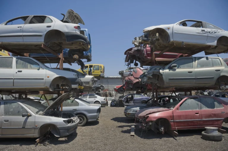 Scrap Cars in the junkyard are stacked on top of one another after junk removal